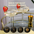 Load image into Gallery viewer, Two elegant cocktail glasses with gold rims on a bar cart, garnished with strawberries, with text 'Serve the most elegant drinks'.