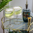 Load image into Gallery viewer, Luxury Vemacity gin glasses with gold rim, filled with cucumber gin and tonic on stylish home bar cart
