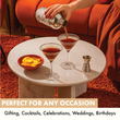 Load image into Gallery viewer, Hand pouring espresso martinis into ribbed glasses on marble table with chips bowl and jigger; perfect for gifting and celebrations.