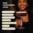 Load image into Gallery viewer, Woman holding ribbed coupe cocktail glass highlighting customer benefits of cocktail shaker gift set.