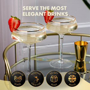 Two elegant cocktail glasses with gold rims on a bar cart, garnished with strawberries, with text 'Serve the most elegant drinks'.