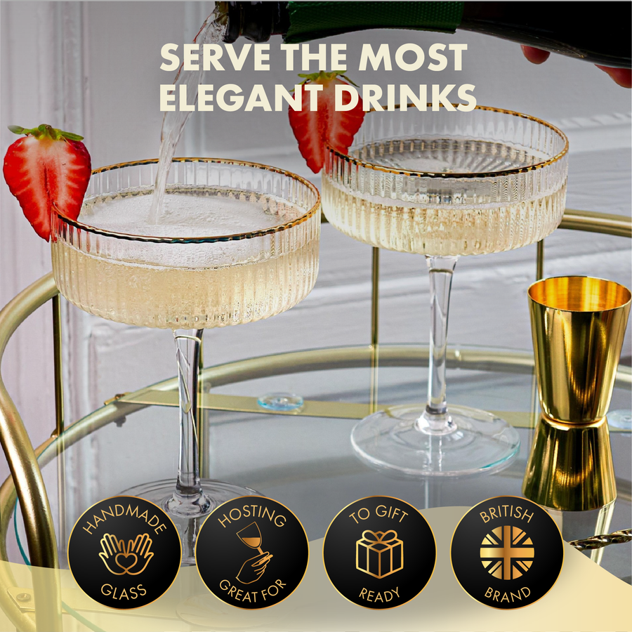 Coupe cocktail glasses with champagne being poured, luxury barware set