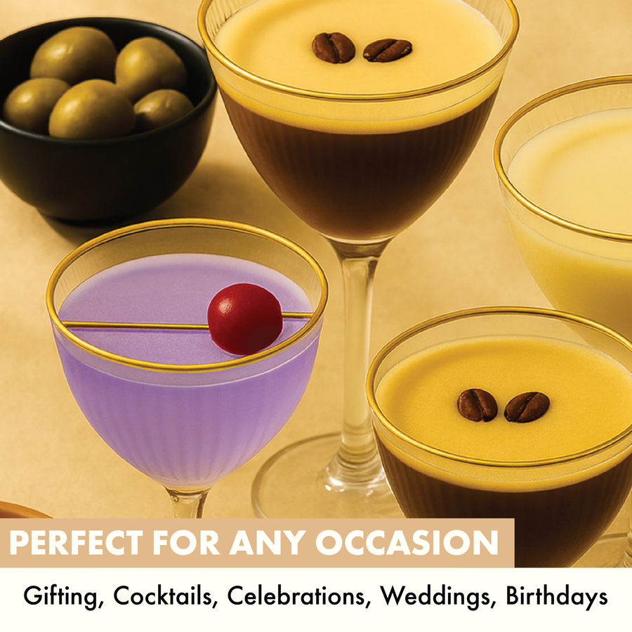 Assorted cocktails in Nick and Nora glasses with gold rims, styled with olives and cherries, showing perfect serve for gifting and celebrations.