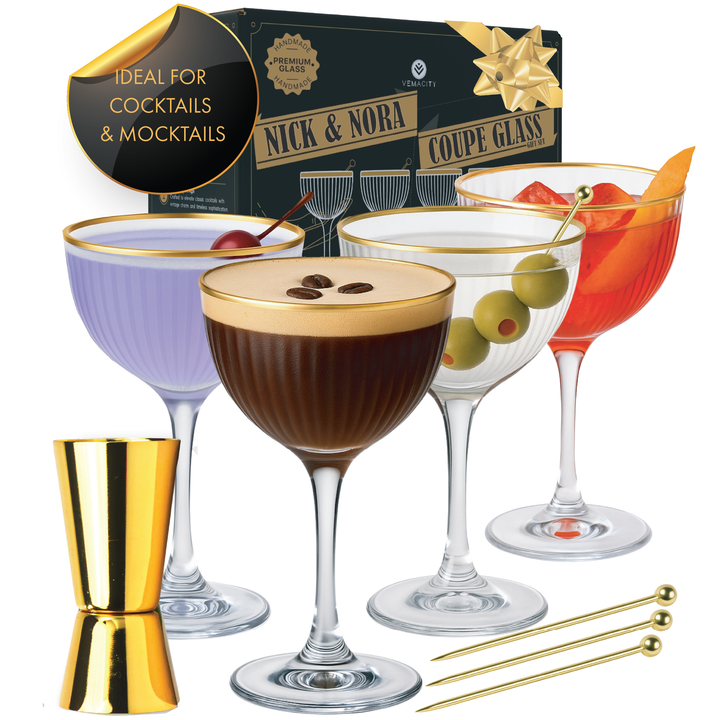 Set of four Nick and Nora glasses with gold rim, filled with colorful cocktails, shown with gold jigger, picks, and luxury Vemacity gift box.