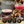 Load image into Gallery viewer, Two coupe glasses with espresso martini and red cocktail served elegantly with holiday lights background
