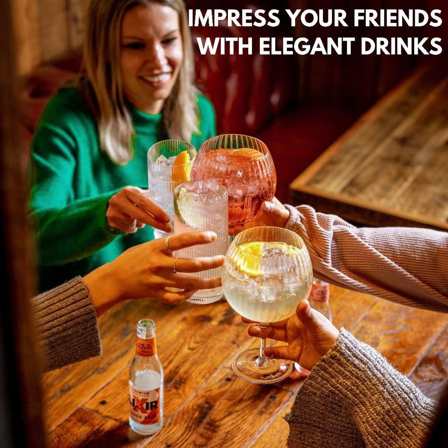 Group of friends toasting with Vemacity ripple copa gin glasses filled with cocktails, perfect glassware for entertaining