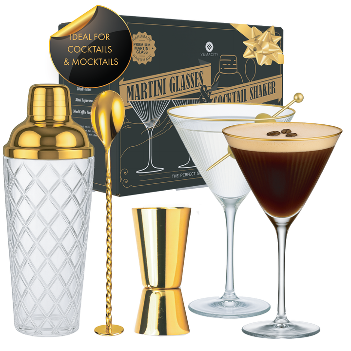 Gold cocktail shaker set with martini glasses, bar spoon, and jigger in luxury gift box.