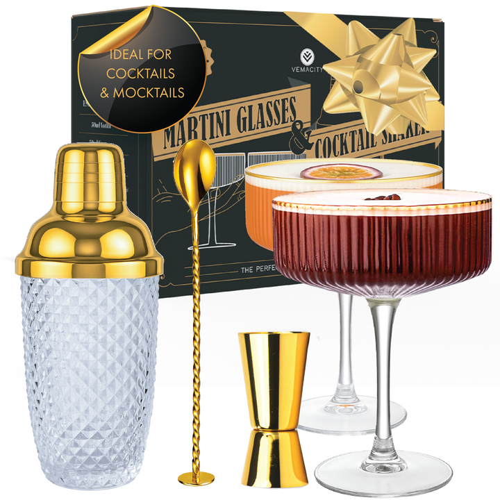 Gold cocktail shaker set with 2 ribbed coupe glasses, jigger, and bar spoon in luxury gift box.