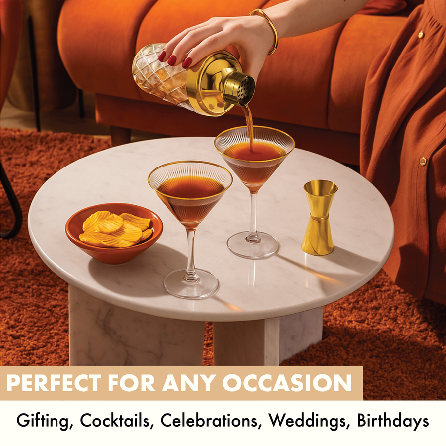 Hand pouring espresso martinis into Vemacity ribbed martini glasses with gold rim, ideal for gifting, weddings, and celebrations.