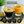 Load image into Gallery viewer, Two Vemacity stemless martini glasses with gold rims, filled with espresso martini and orange cocktail, highlighted with elegant handmade glass design.
